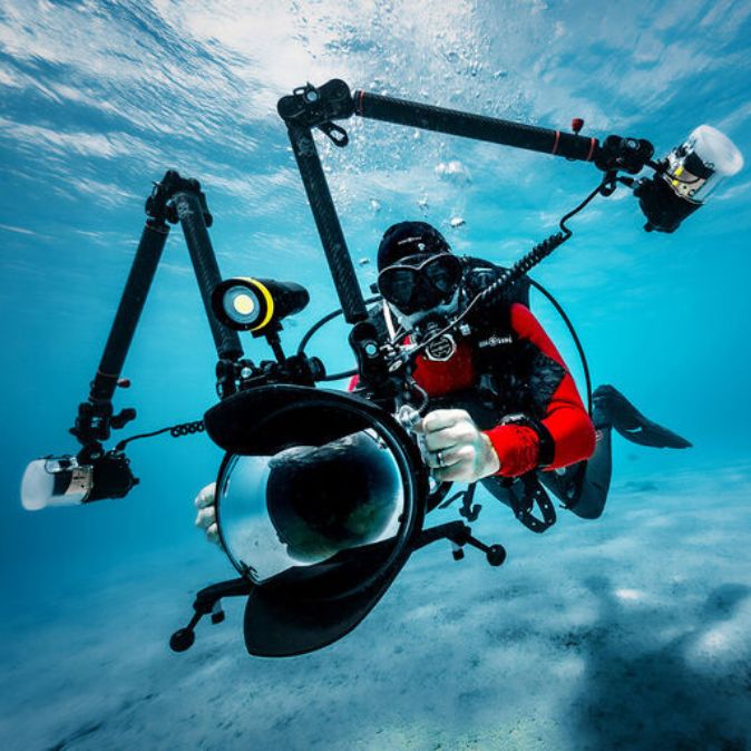 Ambassador Aqualung Lorenzo Mittiga underwater with professional camera setup.
